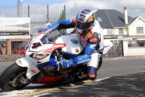 Isle of Man TT: McGuinness sets the pace with 128mph practice lap