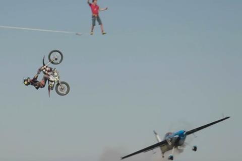 Video: Freestyle motocross rider backflips over stunt plane