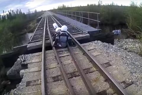 Video: Motorcycle falls through railway bridge