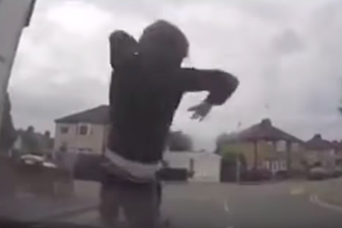 Video: Bizarre moment scooter rider throws himself onto car bonnet